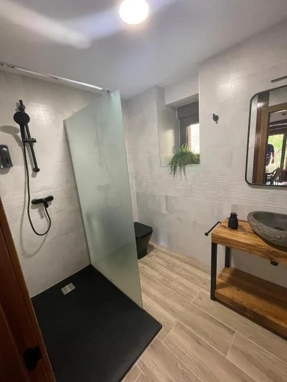 un baño con lavabo y espejo en Cabaña Los Tejos,
